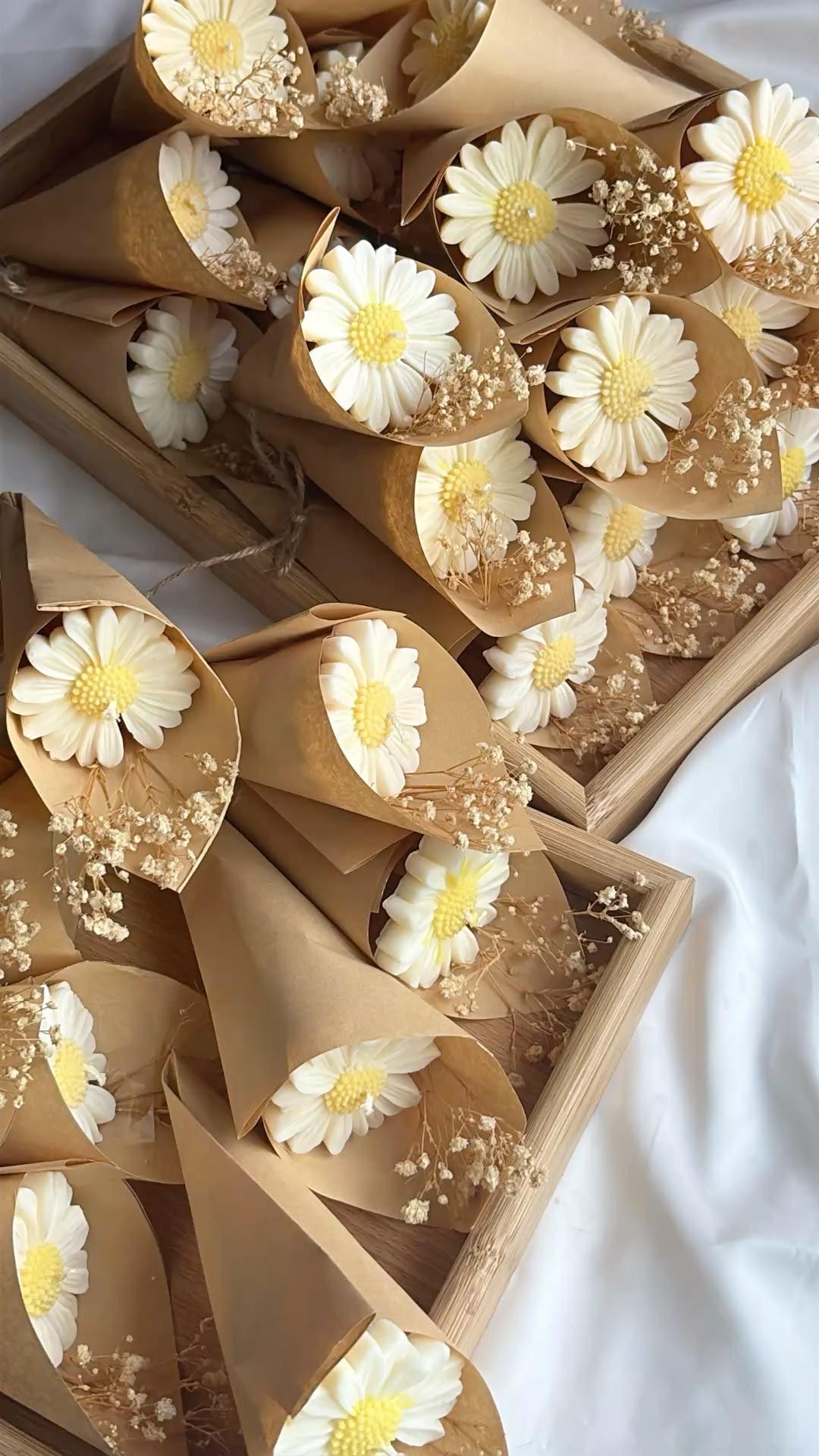 Hand-sculpted daisy candles finished with dried baby's breath.