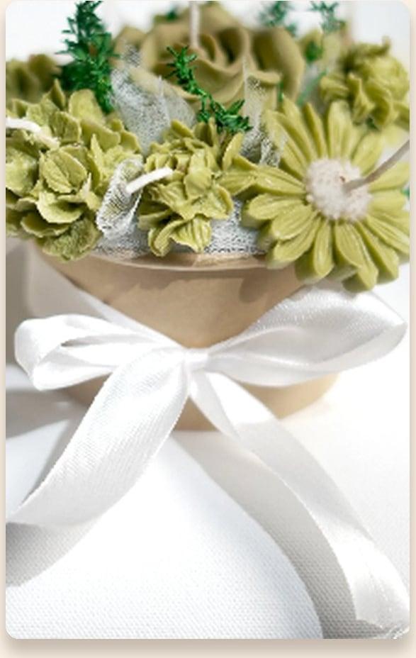 Small sage-green wax flower bouquet tied with a white ribbon